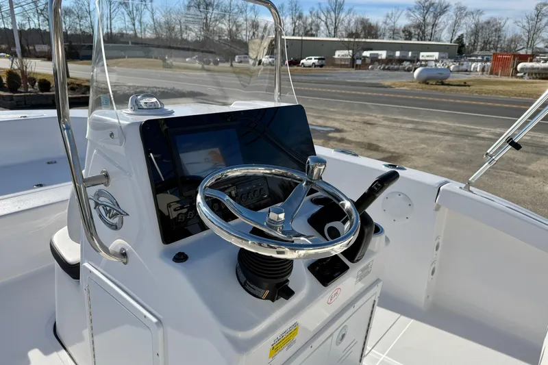 Slide: The Image of 2026 Tidewater 180 CC Adventure boat console with steering wheel and controls. - 13