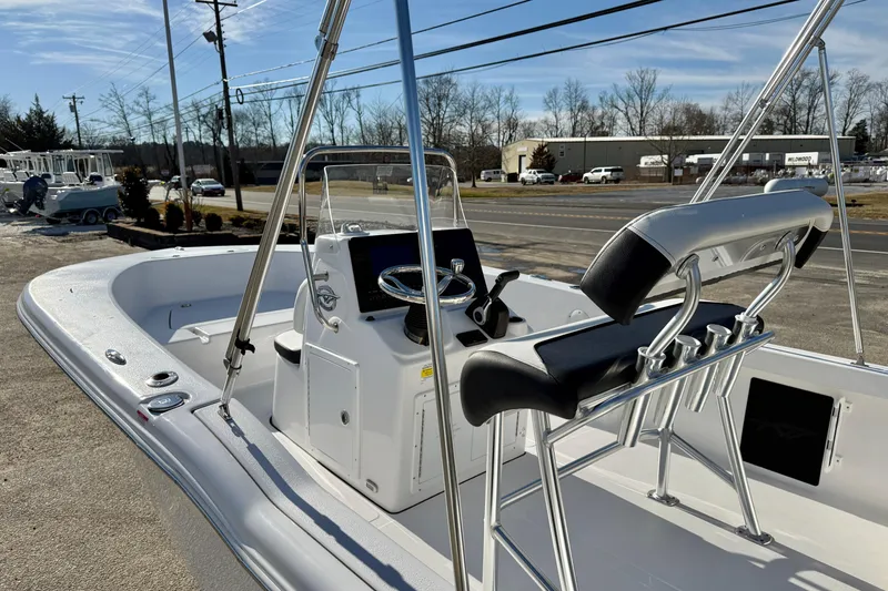 Slide: The Image of 2026 Tidewater 180 CC Adventure boat with sleek console and seating, parked outdoors. - 14