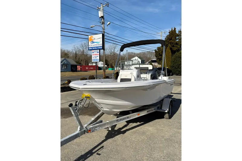 Slide: The Image of 2026 Tidewater 180 CC Adventure boat on trailer, parked outdoors under clear sky. - 20
