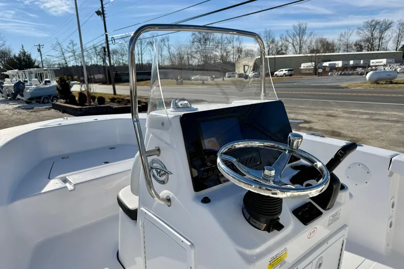 Slide: The Image of 2026 Tidewater 180 CC Adventure boat console with steering wheel and controls. - 22