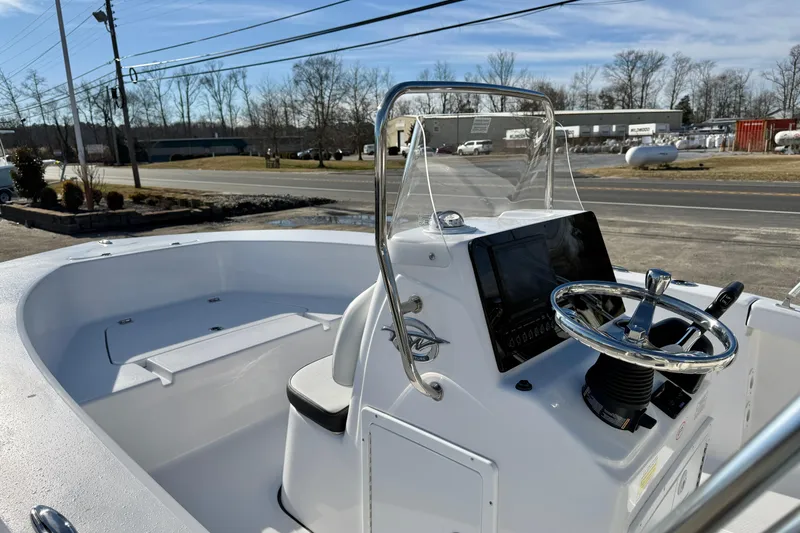 Slide: The Image of 2026 Tidewater 180 CC Adventure boat, featuring sleek console and steering wheel design. - 23