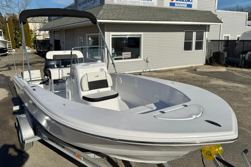 Slide: The Image of 2026 Tidewater 180 CC Adventure boat on trailer outside marine shop. - 26