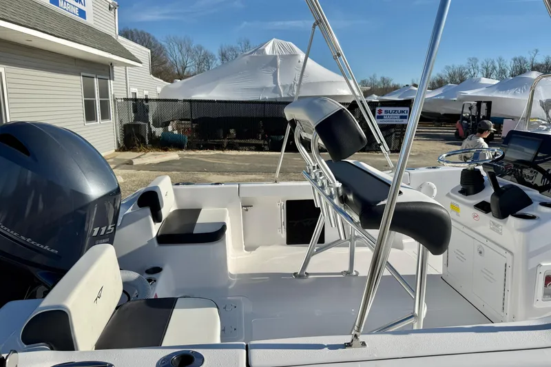 Slide: The Image of 2026 Tidewater 180 CC Adventure boat interior with Yamaha 115 engine, docked near marine shop. - 29