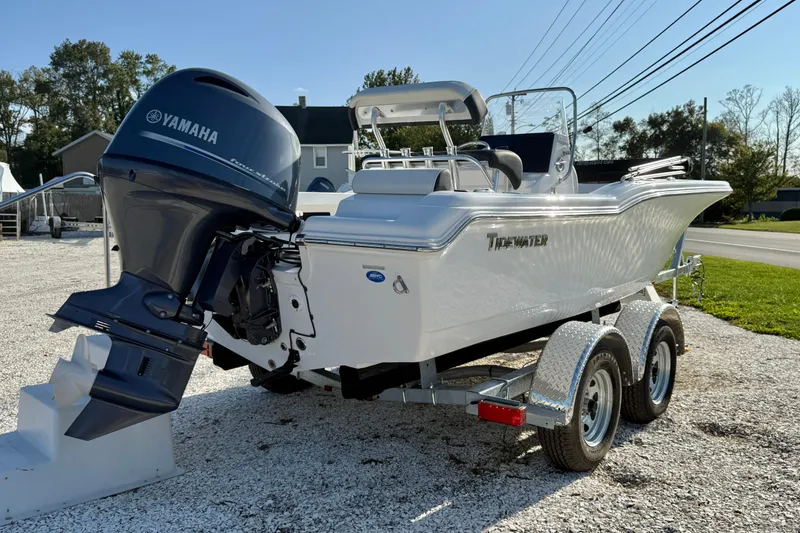 Slide: The Image of 2026 Tidewater 180 CC Adventure boat interior with steering console and seating. - 3