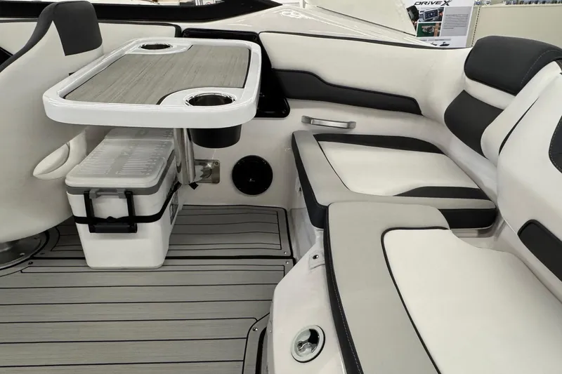 Slide: The Image of 2026 Yamaha Boats 195S interior with seating, table, and cooler. - 16