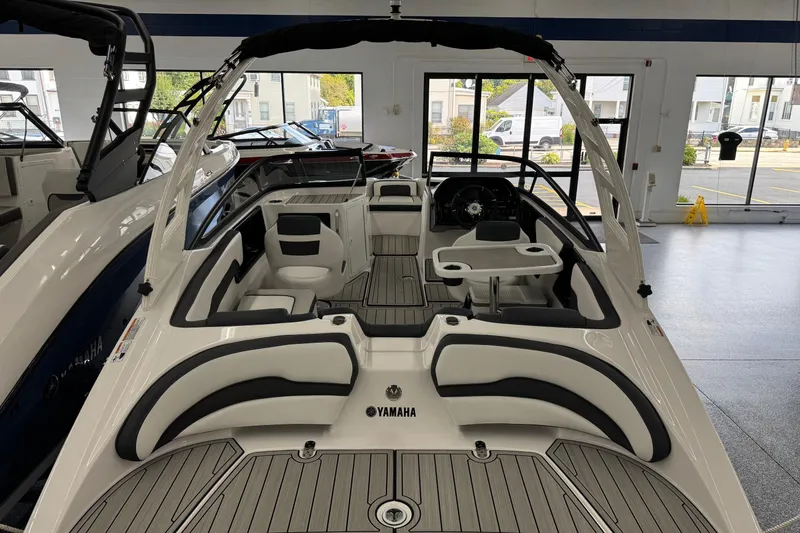 Slide: The Image of 2026 Yamaha Boats 195S interior view in showroom, featuring sleek seating and modern design. - 3