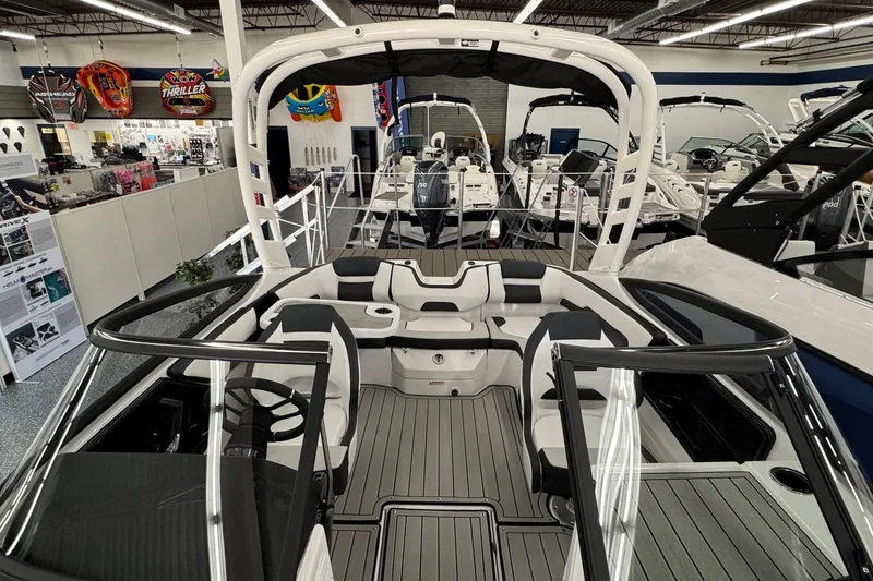 Slide: The Image of 2026 Yamaha Boats 195S interior, showcasing sleek seating and modern design in a showroom setting. - 7