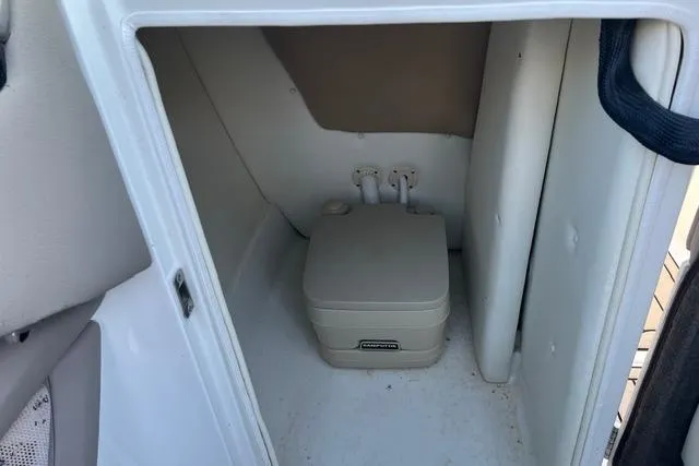 Slide: The Image of Interior of a 2006 Cobalt 272 boat with white seating and sleek design. - 16