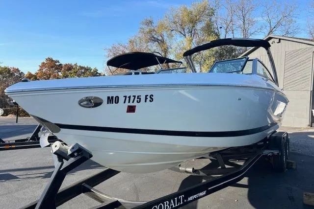 Slide: The Image of 2006 Cobalt 272 boat on trailer, featuring sleek white design and spacious seating. - 21