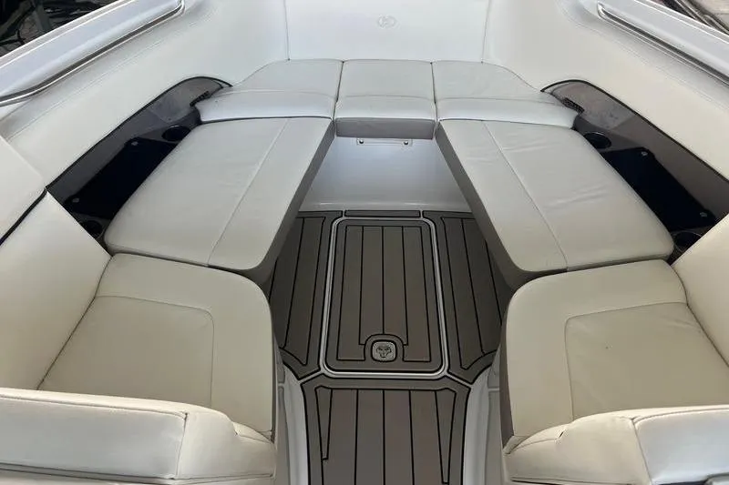 Slide: The Image of 2006 Cobalt 272 boat interior with white cushioned seating and sleek flooring. - 6