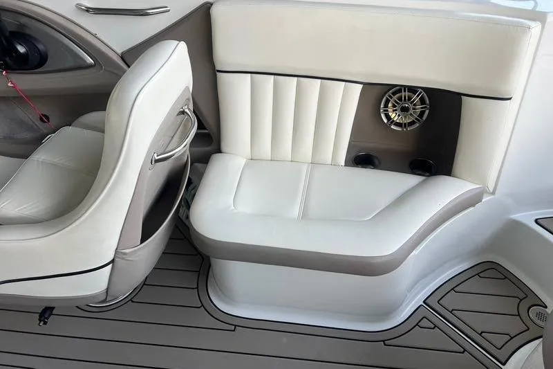 Slide: The Image of Interior of a 2006 Cobalt 272 boat with white leather seating and speaker. - 7