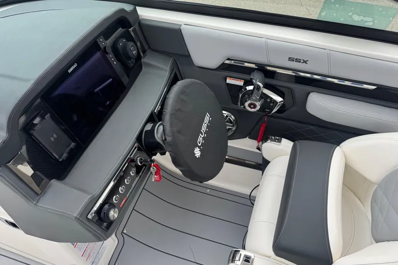 Slide: The Image of 2026 Chaparral 8 SSX boat cockpit with modern controls and luxury seating. - 11