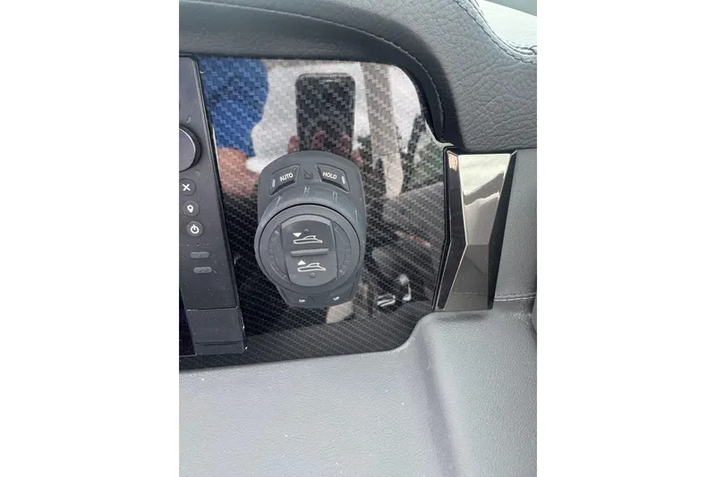 Slide: The Image of 2026 Chaparral 8 SSX dashboard control panel with carbon fiber finish. - 12