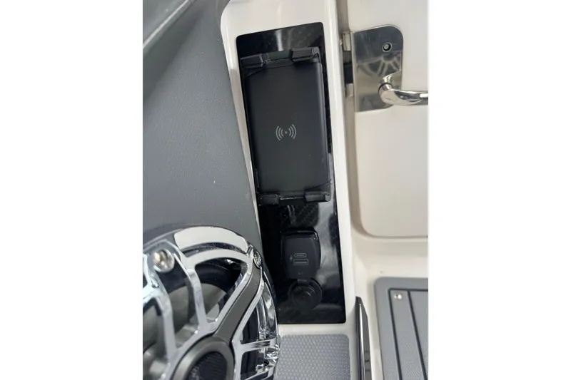 Slide: The Image of 2026 Chaparral 8 SSX boat interior with wireless charging pad and speaker. - 14