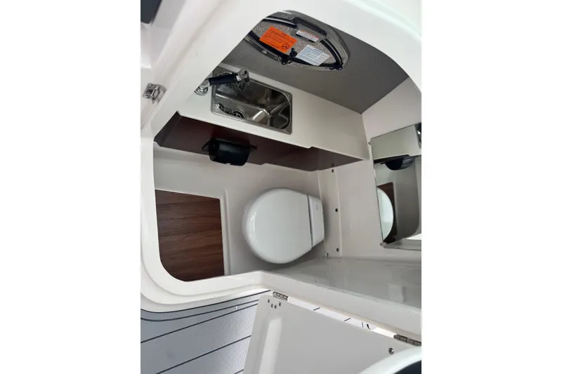 Slide: The Image of 2026 Chaparral 8 SSX boat interior with compact bathroom and sink. - 16
