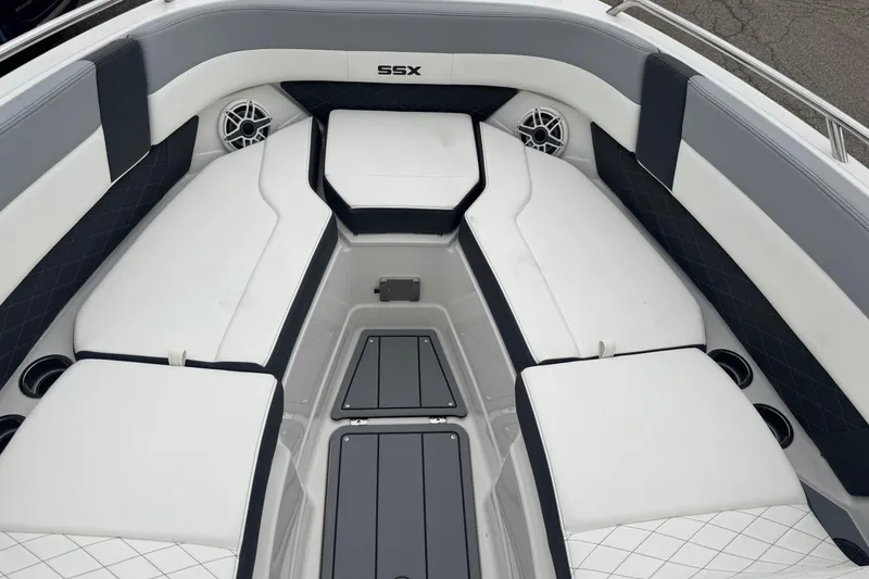Slide: The Image of 2026 Chaparral 8 SSX boat interior with white and gray seating, cup holders, and speakers. - 17