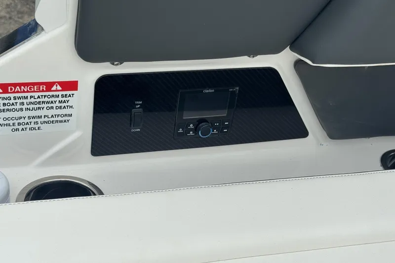 Slide: The Image of 2026 Chaparral 8 SSX boat interior with control panel and safety warning. - 8