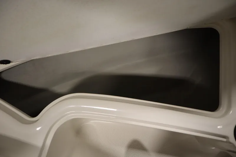 Slide: The Image of Storage compartment of a 2013 Bayliner 175 Bowrider boat, featuring sleek interior design. - 13