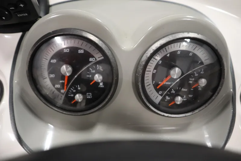 Slide: The Image of Dashboard gauges of a 2013 Bayliner 175 Bowrider boat, showing speed and RPM. - 18