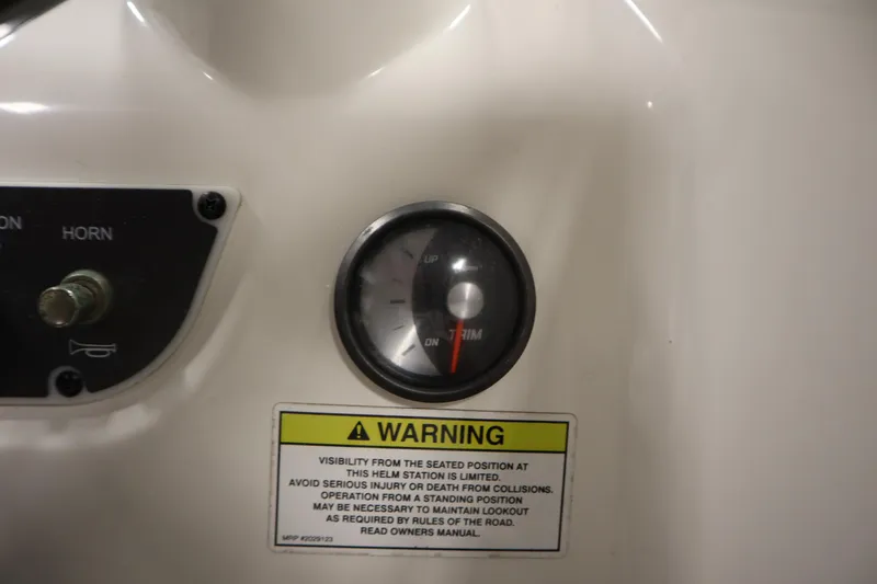 Slide: The Image of Dashboard of 2013 Bayliner 175 Bowrider with warning label and trim gauge. - 21