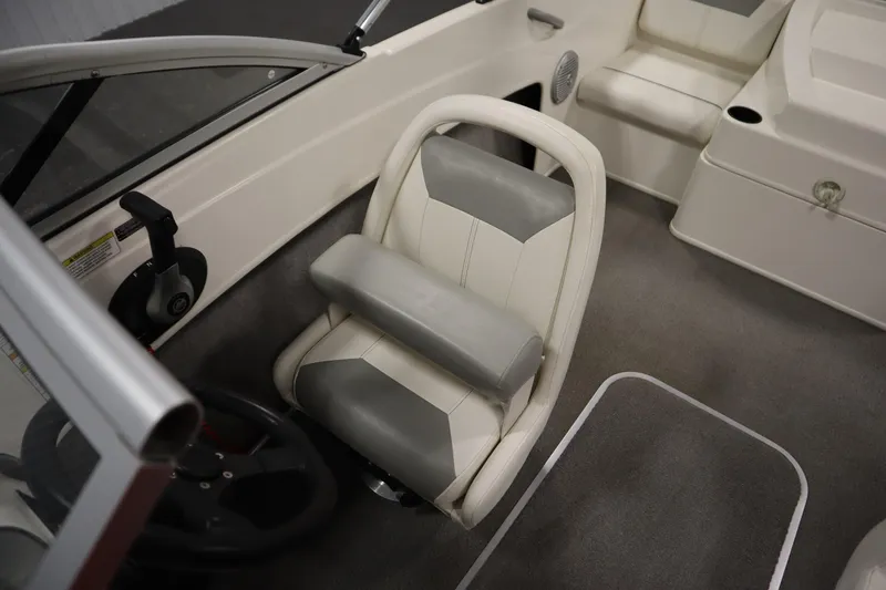 Slide: The Image of 2013 Bayliner 175 Bowrider interior with steering wheel and cushioned seat. - 23