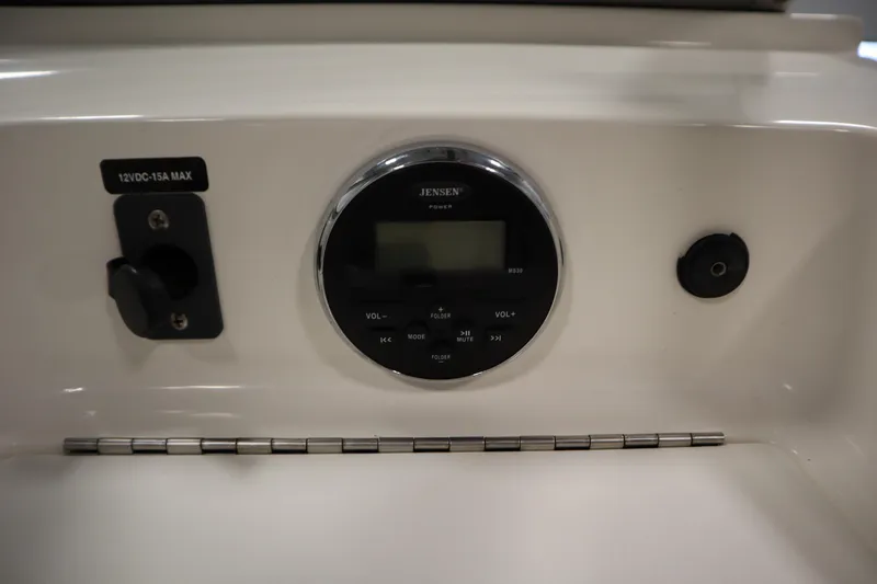 Slide: The Image of 2013 Bayliner 175 Bowrider dashboard with Jensen audio system and 12V power outlet. - 26