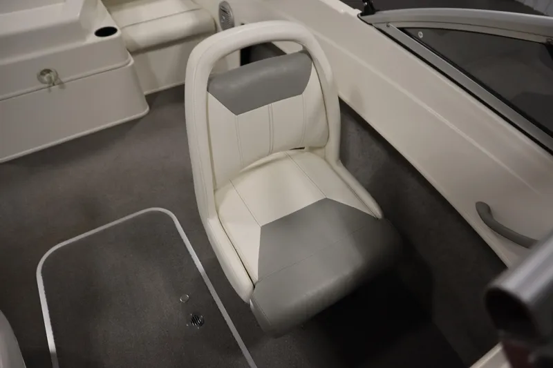Slide: The Image of Interior seating of a 2013 Bayliner 175 Bowrider boat, featuring gray and white upholstery. - 28