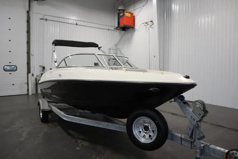 Slide: The Image of 2013 Bayliner 175 Bowrider on trailer in indoor storage facility. - 3