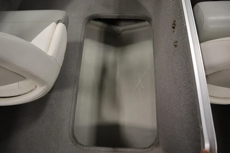 Slide: The Image of 2013 Bayliner 175 Bowrider interior storage compartment with gray carpet and white seating. - 30