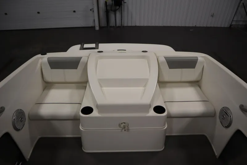 Slide: The Image of 2013 Bayliner 175 Bowrider interior with white seating and cup holders. - 31