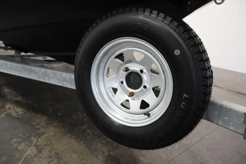 Slide: The Image of Trailer wheel for 2013 Bayliner 175 Bowrider boat on metal frame. - 41