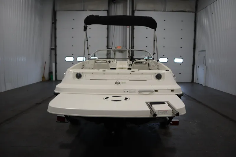 Slide: The Image of 2013 Bayliner 175 Bowrider boat in indoor storage, rear view. - 6