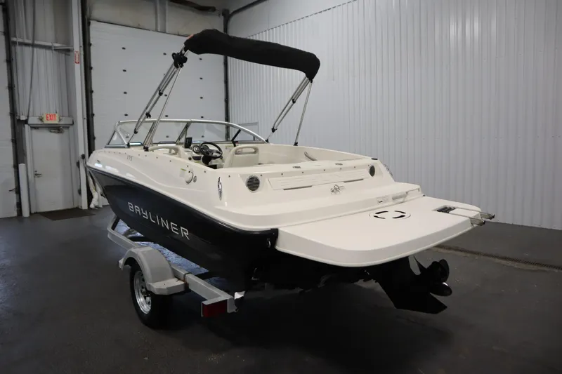 Slide: The Image of 2013 Bayliner 175 Bowrider boat in a garage, rear view with trailer. - 7