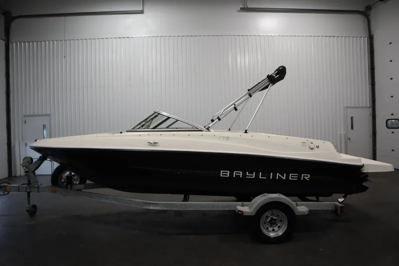 Slide: The Image of 2013 Bayliner 175 Bowrider boat on trailer in indoor storage facility. - 8