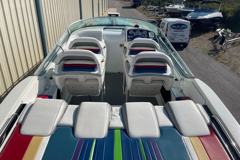 Slide: The Image of 2004 Formula 382 FASTech boat interior with colorful seating and dashboard. - 14