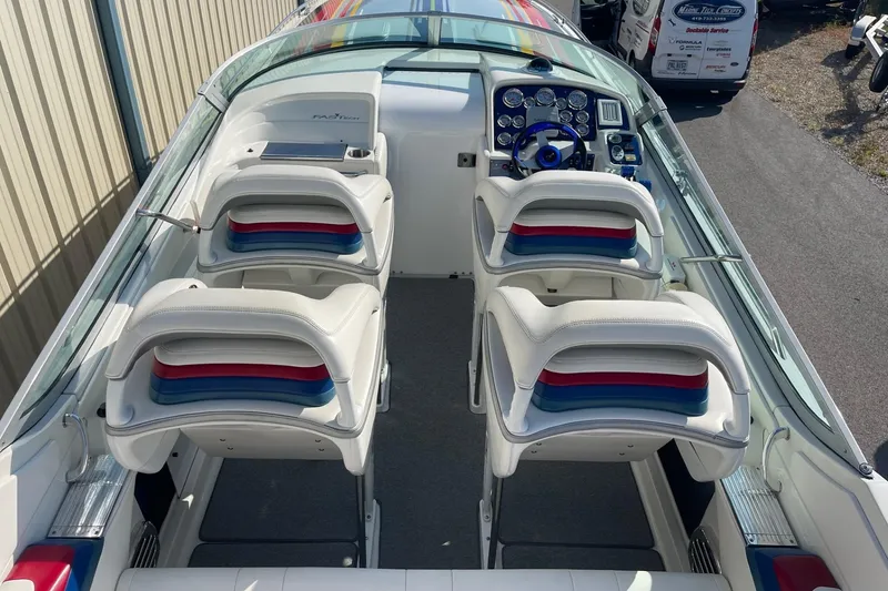 Slide: The Image of 2004 Formula 382 FASTech boat interior with white seating and colorful accents. - 15
