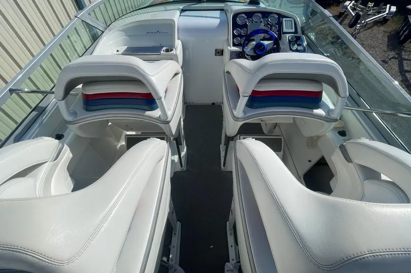 Slide: The Image of 2004 Formula 382 FASTech boat interior with white seating and control panel. - 21