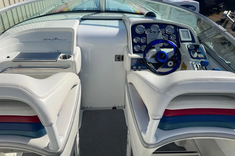 Slide: The Image of 2004 Formula 382 FASTech boat interior with white seating and blue steering wheel. - 22