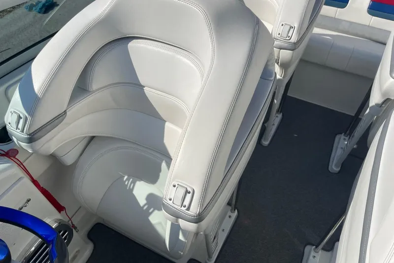 Slide: The Image of 2004 Formula 382 FASTech boat interior with white leather seats and blue steering wheel. - 26