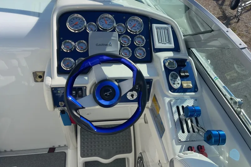 Slide: The Image of 2004 Formula 382 FASTech boat dashboard with blue accents and Garmin navigation system. - 27