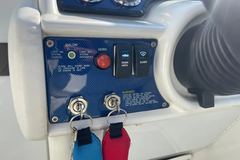 Slide: The Image of Control panel of a 2004 Formula 382 FASTech boat with switches and warning labels. - 28