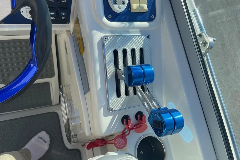 Slide: The Image of 2004 Formula 382 FASTech boat cockpit with blue throttle controls and steering wheel. - 32