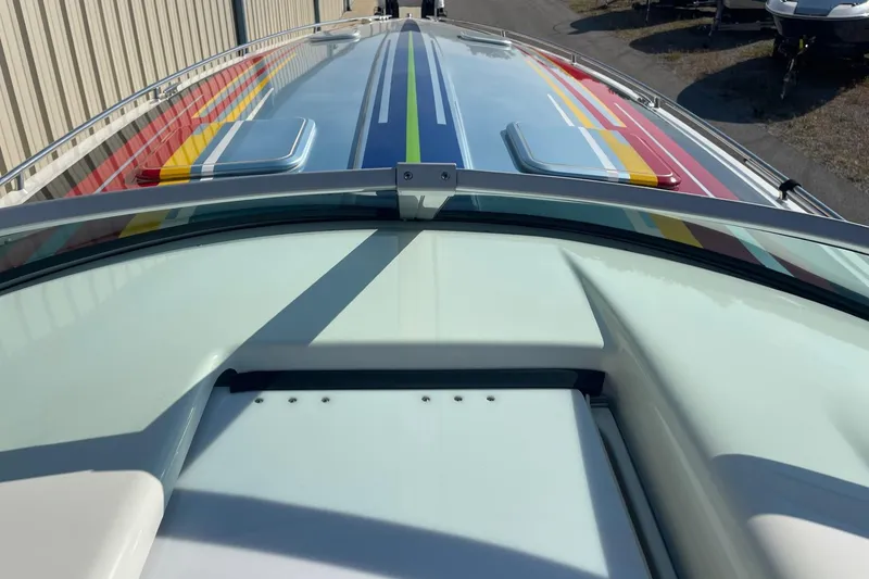 Slide: The Image of 2004 Formula 382 FASTech boat with colorful striped design on deck. - 38
