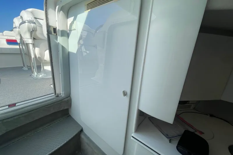 Slide: The Image of Interior view of a 2004 Formula 382 FASTech boat, featuring seating and cabin entry. - 42