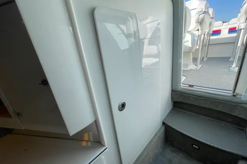 Slide: The Image of Interior view of a 2004 Formula 382 FASTech boat, featuring sleek white cabinetry and seating. - 46