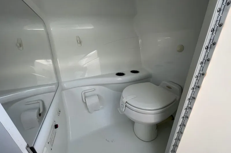 Slide: The Image of 2004 Formula 382 FASTech boat bathroom with white toilet and sleek design. - 48
