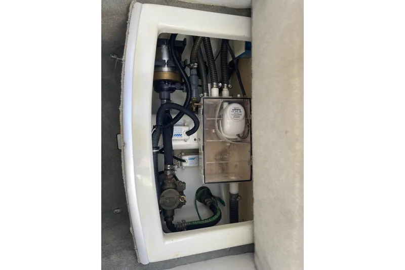 Slide: The Image of 2004 Formula 382 FASTech engine compartment with visible hoses and components. - 49