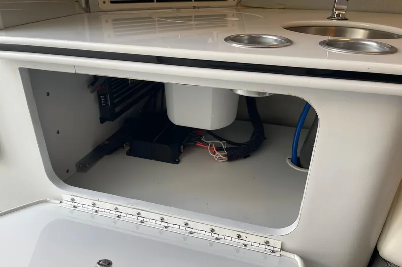 Slide: The Image of 2004 Formula 382 FASTech boat interior storage compartment with wiring and sink. - 52