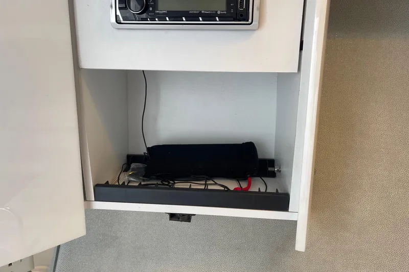 Slide: The Image of Open cabinet in 2004 Formula 382 FASTech boat with stereo system and wiring. - 55