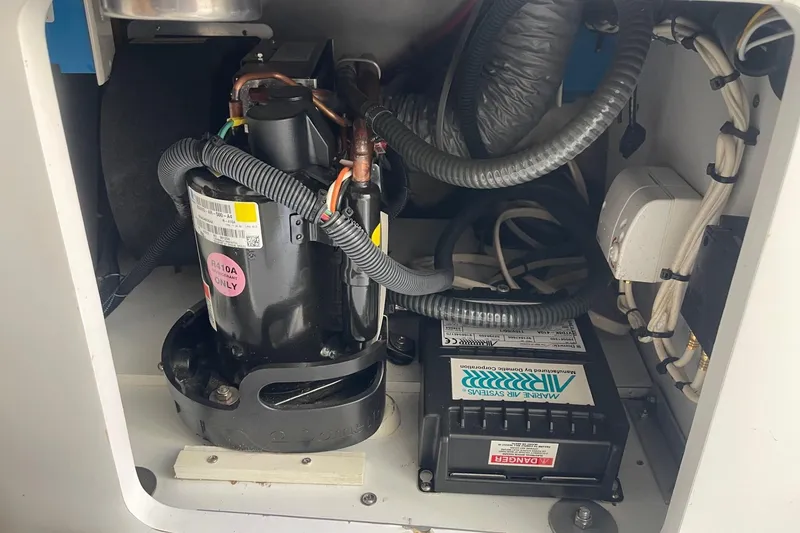 Slide: The Image of Engine compartment of a 2004 Formula 382 FASTech boat, featuring wiring and components. - 56